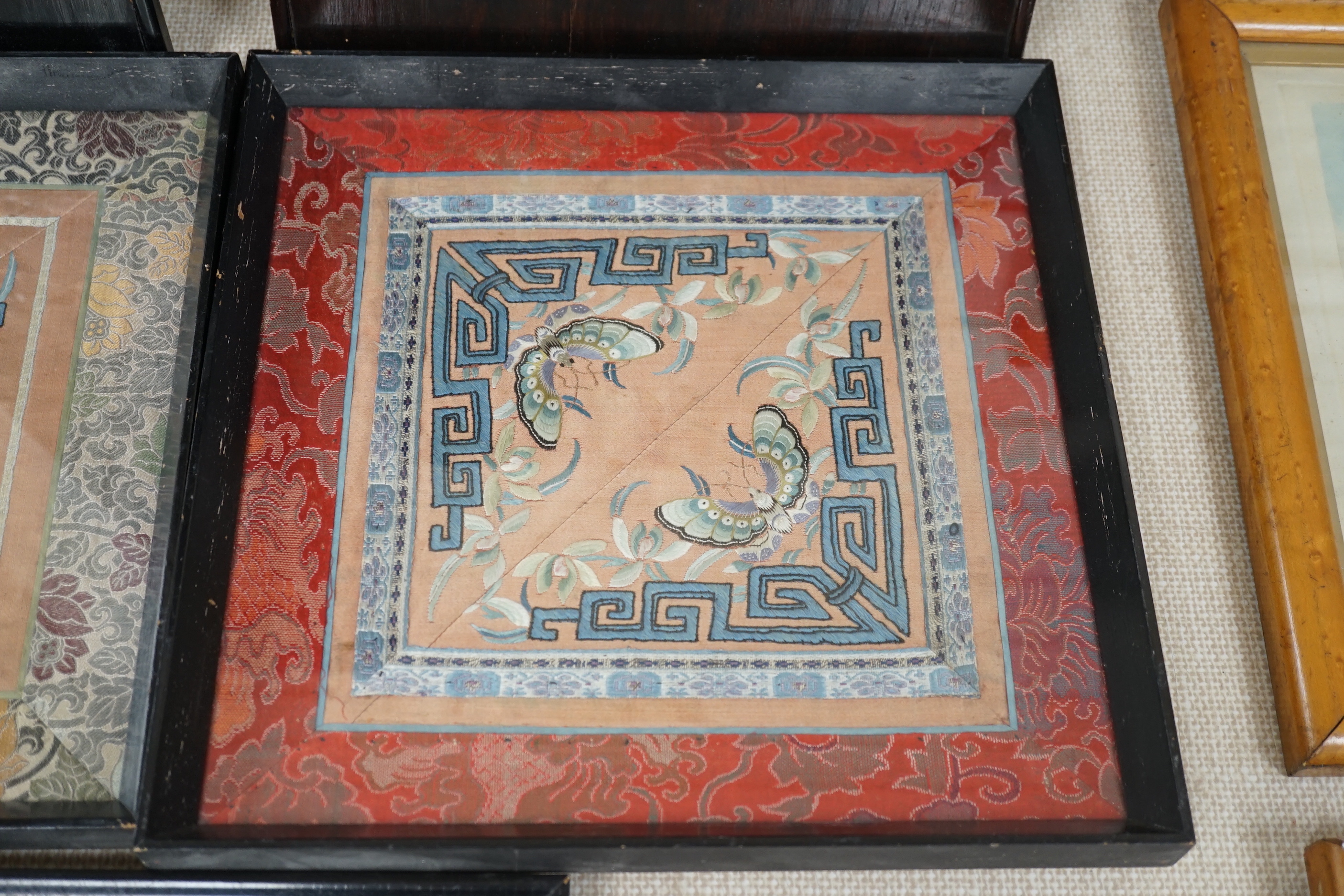 Three framed Chinese silk embroidered panels including a Beijing knot embroidered panel, two with applied butterflies, largest frame 31cm x 31cm